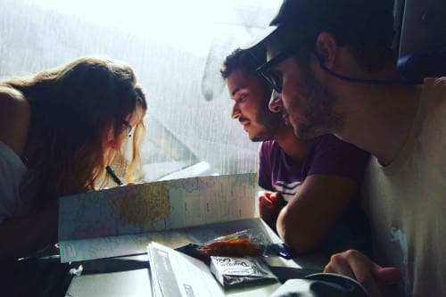 Everything about Eurail | Three people looking in the map in the train